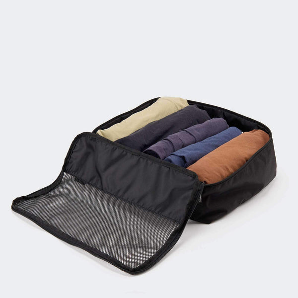 Pander set of six packing cubes in Onyx Black, open cube holding folded clothing