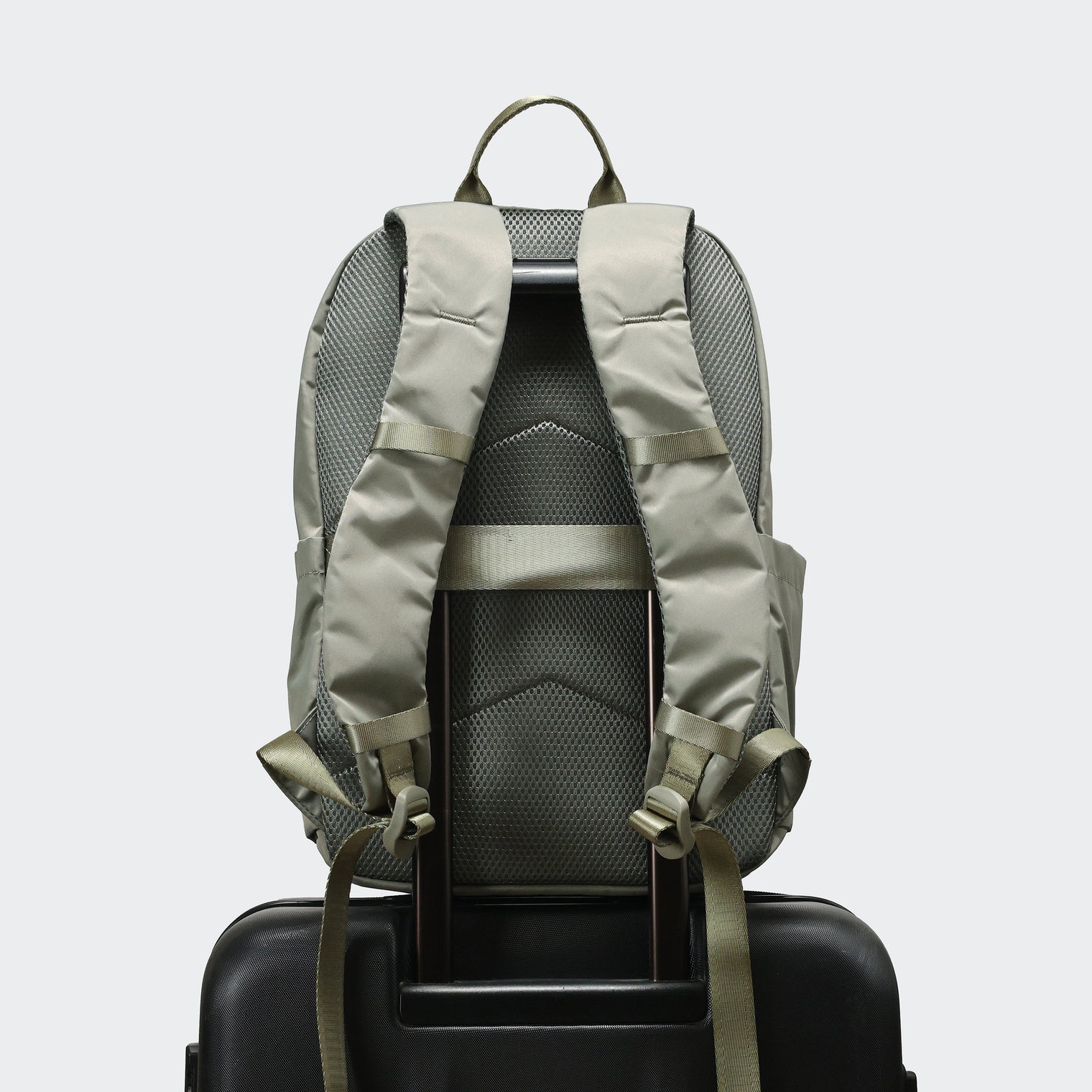 Pander 22L Grey Sage backpack rear luggage sleeve on suitcase handle