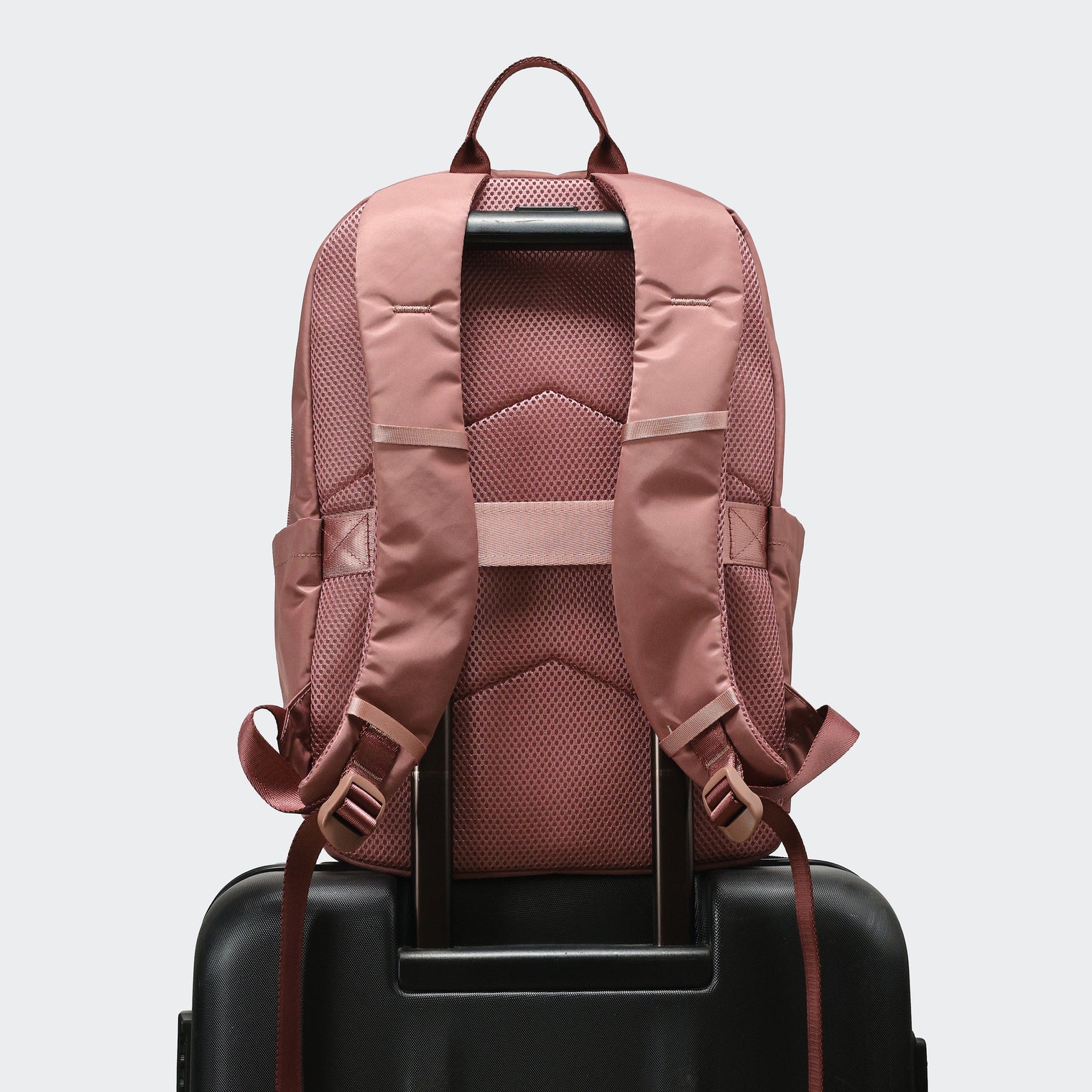 Pander 22L Mauve backpack rear luggage sleeve on suitcase handle