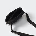 Black dual-zip belt bag open to show divided interior mesh pockets