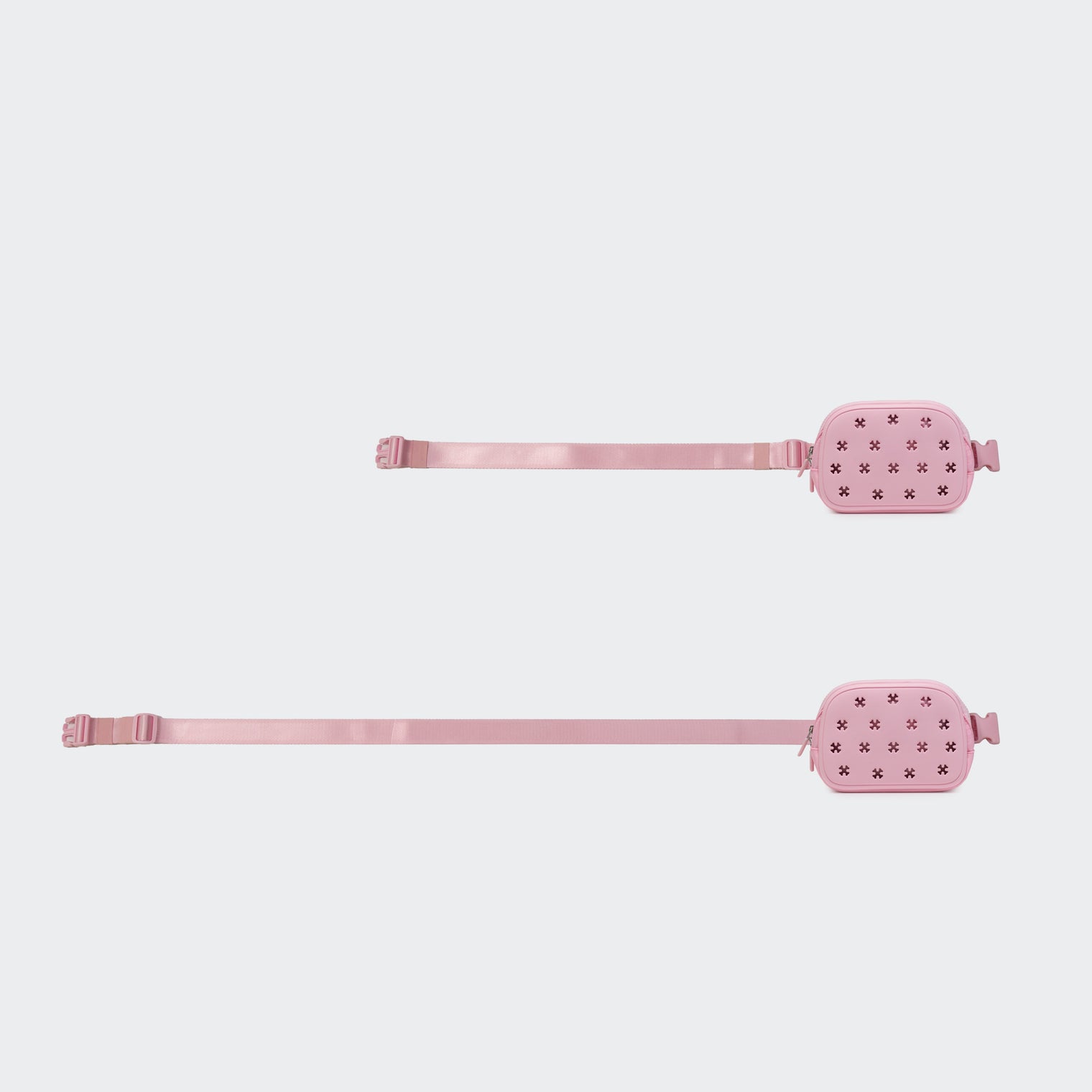 Pink belt bag shown with adjustable webbing at two strap lengths on #ECEDEF background