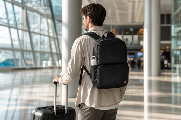 Pander 22L black everyday commuter backpack worn by a traveler in a modern airport