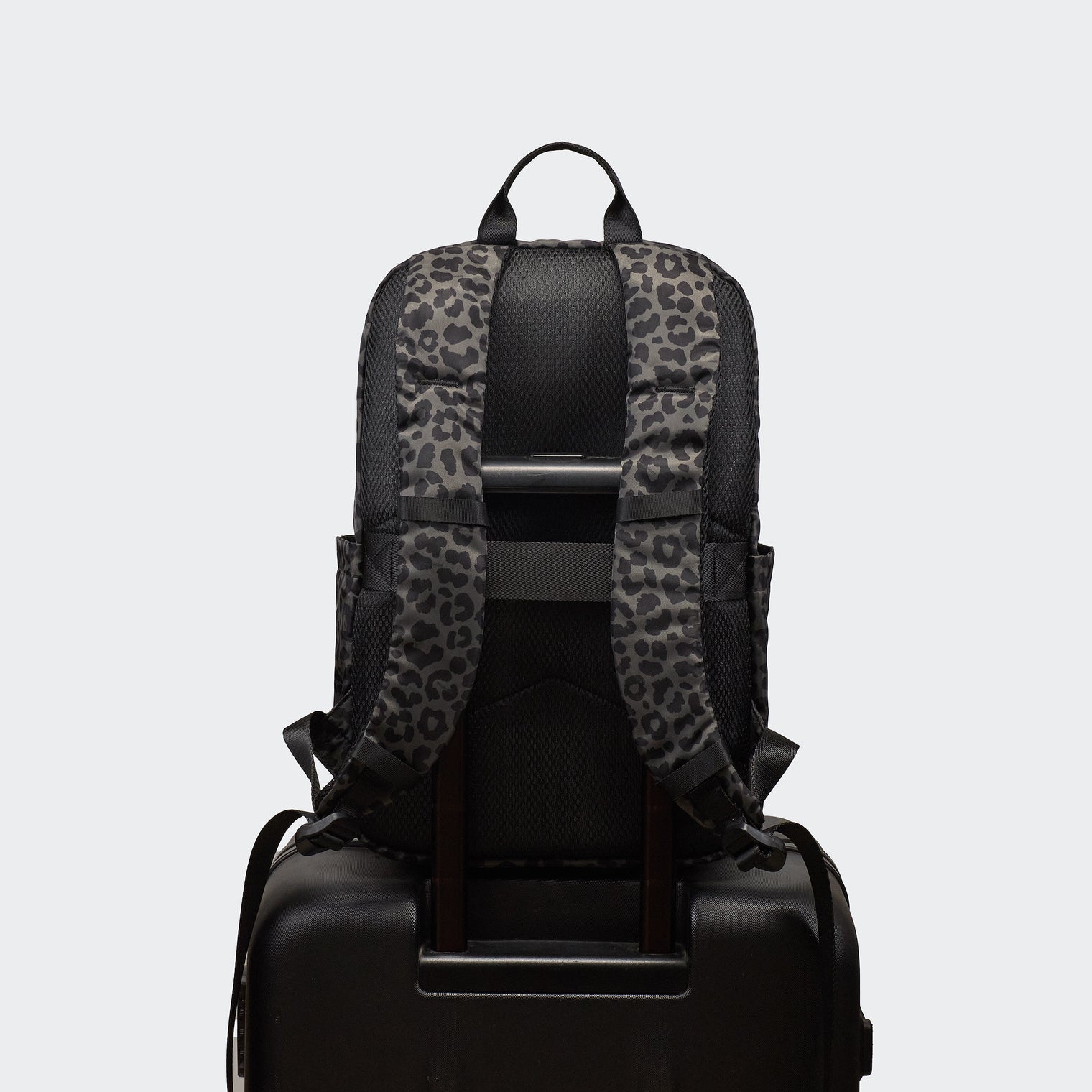 Pander 22L Grey Leopard backpack rear luggage sleeve on suitcase handle